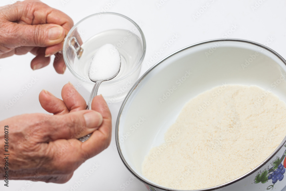 Colombian arepa dough preparation: Add salt to warm water Colombian arepa dough preparation: Add salt to warm water