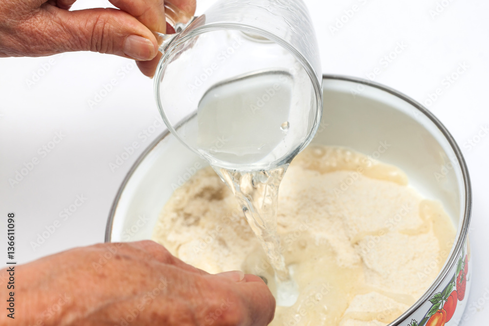 Colombian arepa dough preparation: Add salted warm water to the cornmeal Colombian arepa dough preparation: Add salted warm water to the cornmeal