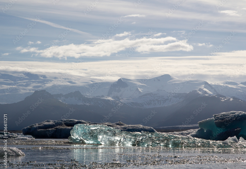 Very shiny glass-like iceberg floating on Jokulsarlon glacial lagoon