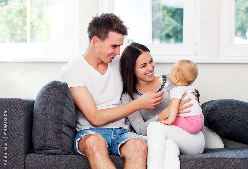 Happy couple with baby child.