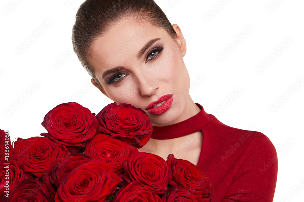 Beautiful model posing with red roses in the studio. Beautiful model posing with red roses in the studio.