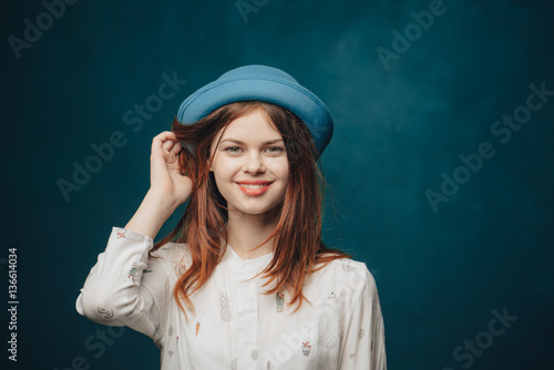 red-haired woman in a blue hat