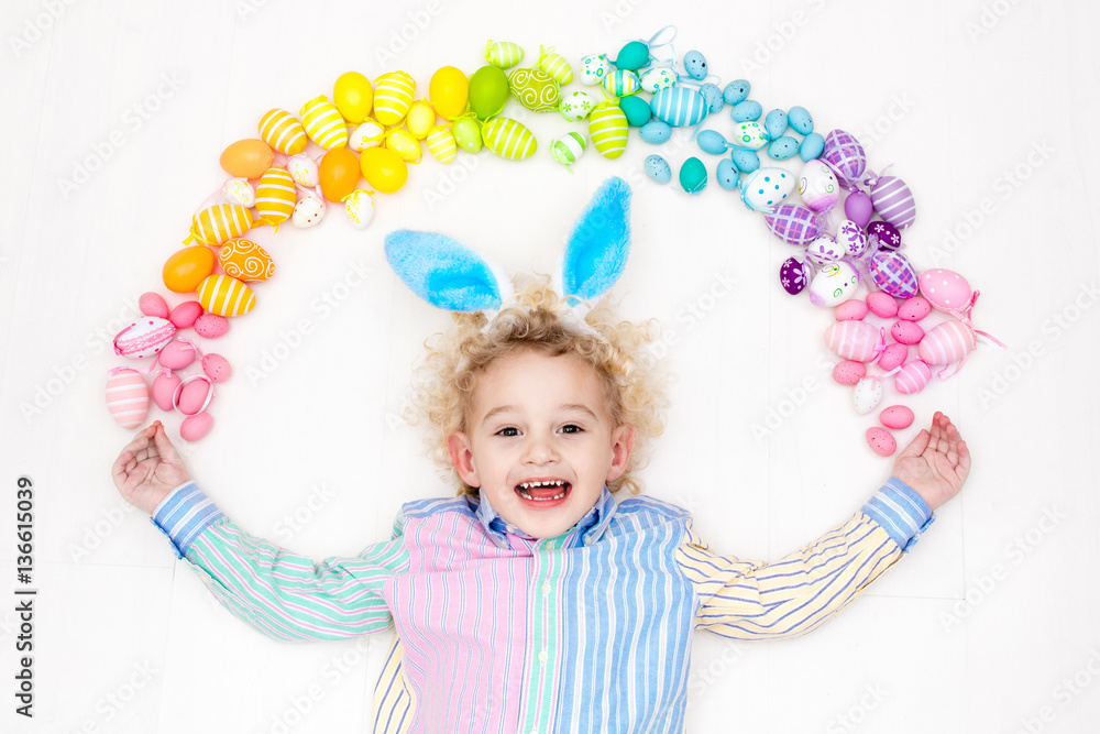 Child on Easter egg hunt. Pastel rainbow eggs. Child on Easter egg hunt. Pastel rainbow eggs.