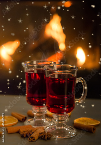 Two glasses of tea in front of the fireplace