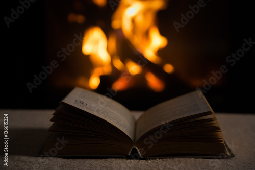 Open book in front of fireplace