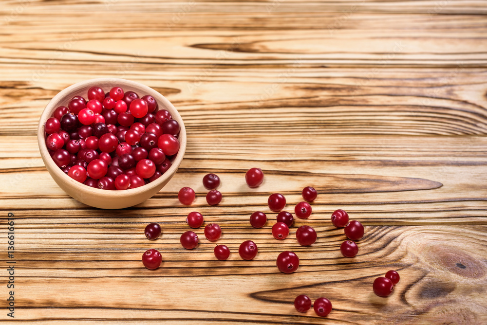 Cranberry. Cranberries on glay Plate Wooden Background Cranberry. Cranberries on glay Plate Wooden Background