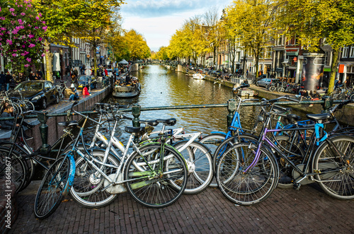 Parked bicycles near canal in Amsterdam, Netherlands