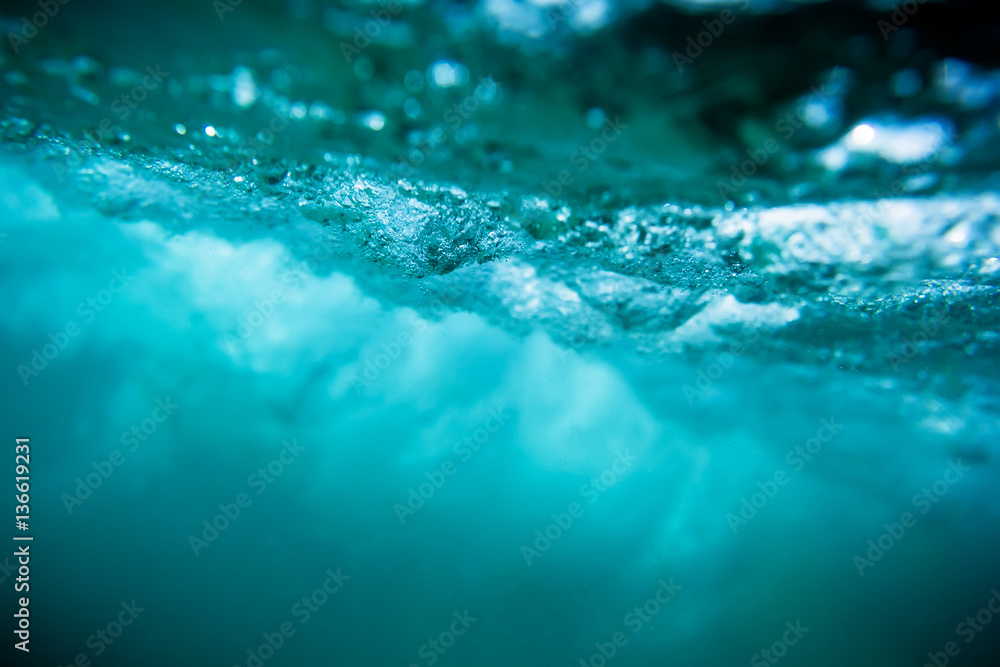 Wave underwater. Blue ocean in underwater