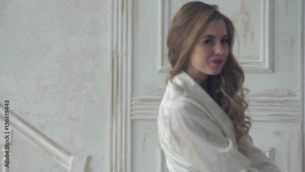 girl in lingerie standing next to a wall in a luxurious translucent negligee girl in lingerie standing next to a wall in a luxurious translucent negligee