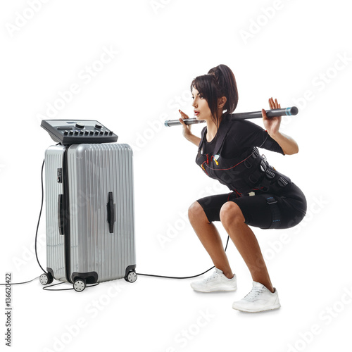 EMS fitness woman. Squatting exercise with body bar