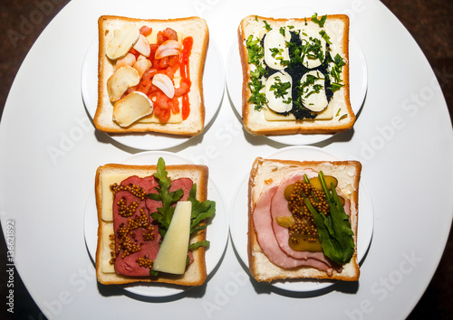 Four types of sandwiches with different ingredients for breakfast