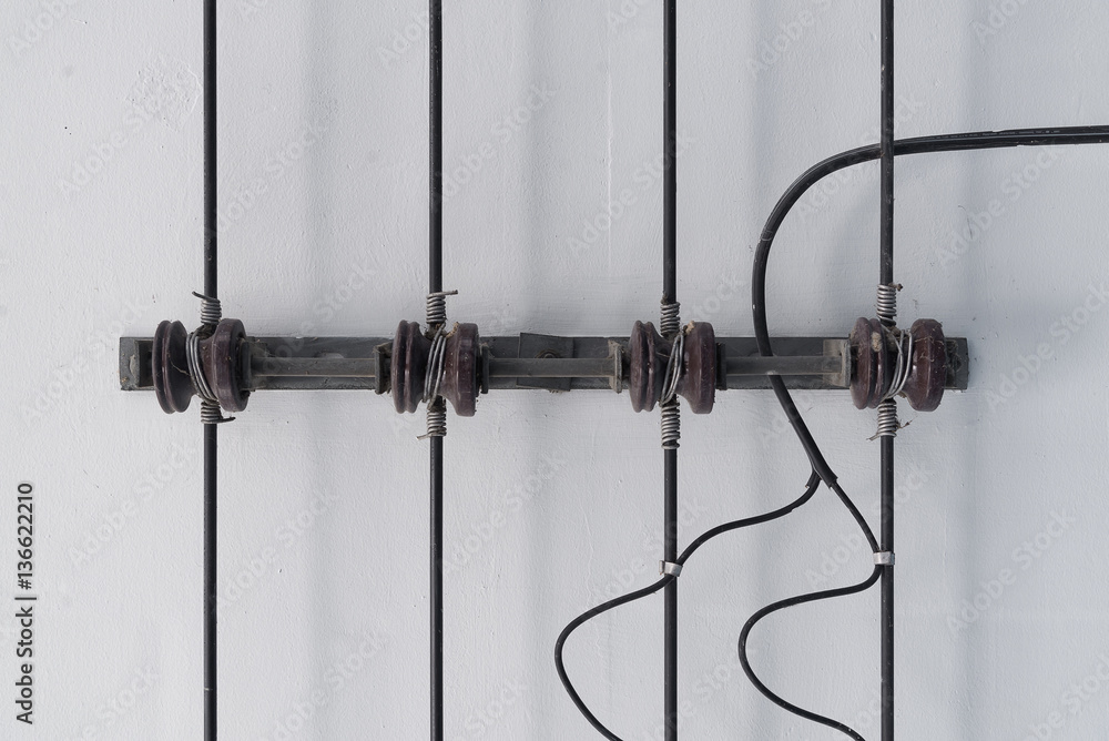 Power line and porcelain insulators with rack on ceiling. Power line and porcelain insulators with rack on ceiling.