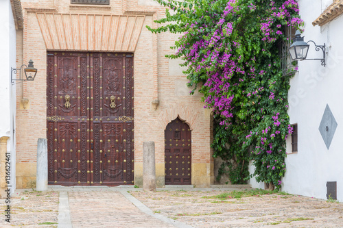 CORDOBA, SPAIN - MAY 26, 2015:  House facade and carved gate from Plaza del Jeronimo Paez square. photo