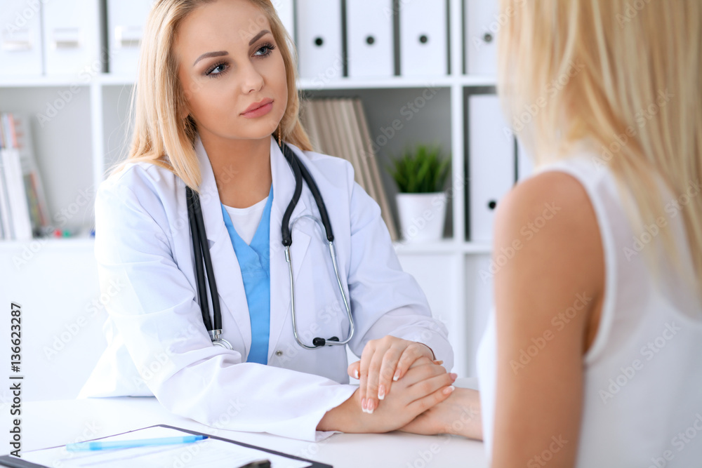 Doctor reassuring her female patient. Medicine, help and health care concept Doctor reassuring her female patient. Medicine, help and health care concept