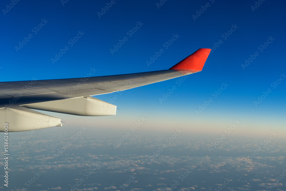 scene of wing of aircarft on blue sky and cloudscape - can use to display or montage on product scene of wing of aircarft on blue sky and cloudscape - can use to display or montage on product