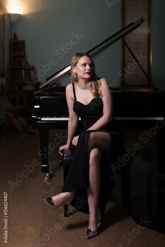 Beautiful Young Woman Playing the Piano
