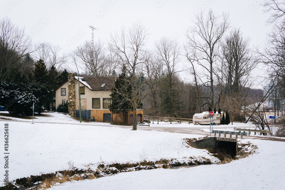 Creek in a snow covered field and house, near Glenville, Pennsyl