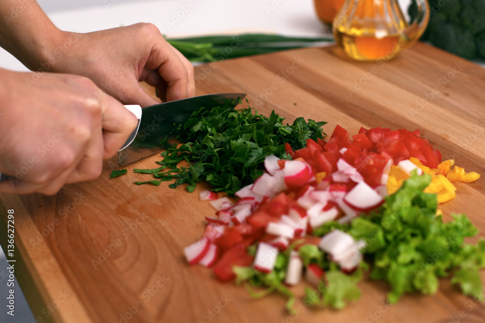 Close up of woman's hands cooking in the kitchen. Housewife slicing white bread. Vegetarian and healthily cooking concept Close up of woman's hands cooking in the kitchen. Housewife slicing white bread. Vegetarian and healthily cooking concept