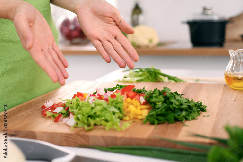 Close up of  woman's hands cooking in the kitchen. Housewife slicing ​​white bread. Vegetarian and healthily cooking concept