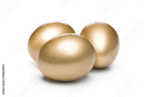 Golden eggs on a white background