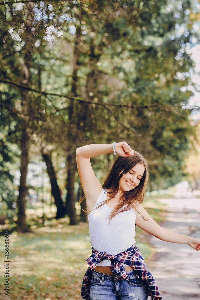 young beautiful girl walking park