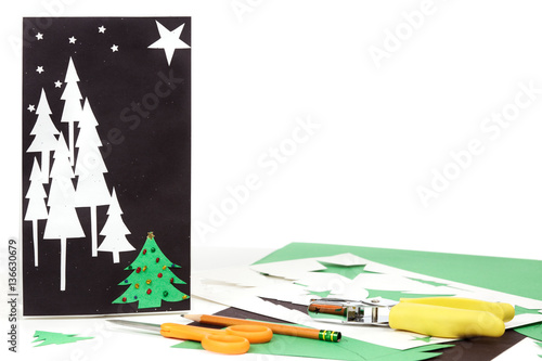 Construction paper, bag, stencils, pencil decorative hold punch and scissors to make Christmas gift bags