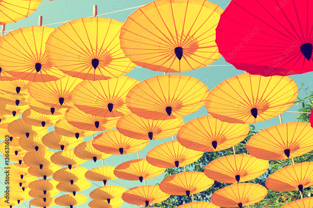 Decoration by colorful umbrella with sky background.