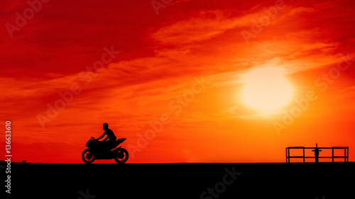 silhouette Motor bike on a road in the sunset