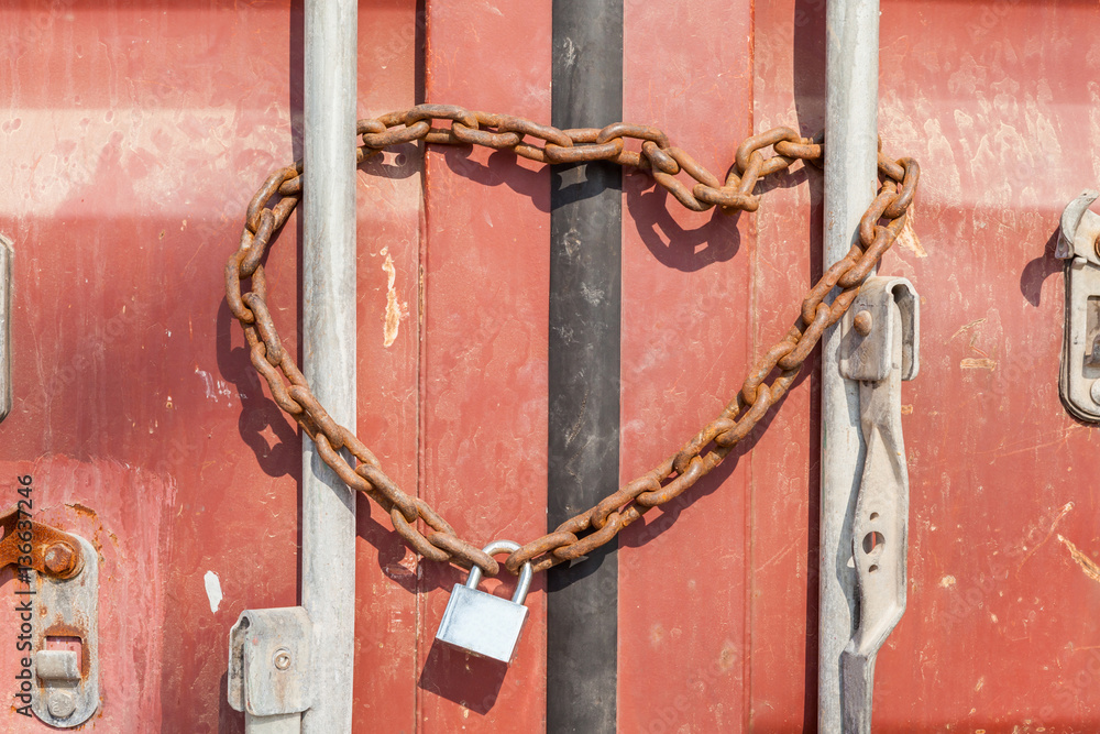 Security and Safety concept, a rusty metal chain and padlock wra Security and Safety concept, a rusty metal chain and padlock wra