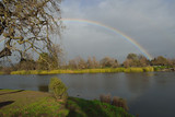 Rainbow over lake with trees in background