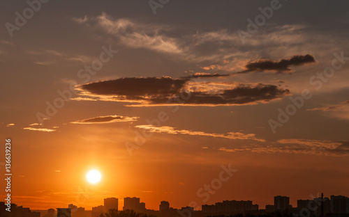 Sunset with bright Sun over skyline. Moscow, Russia.