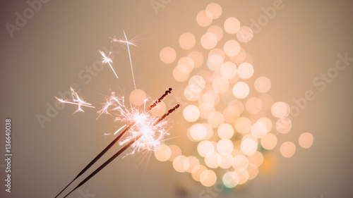 Festive sparklers with tree shaped bokeh lights