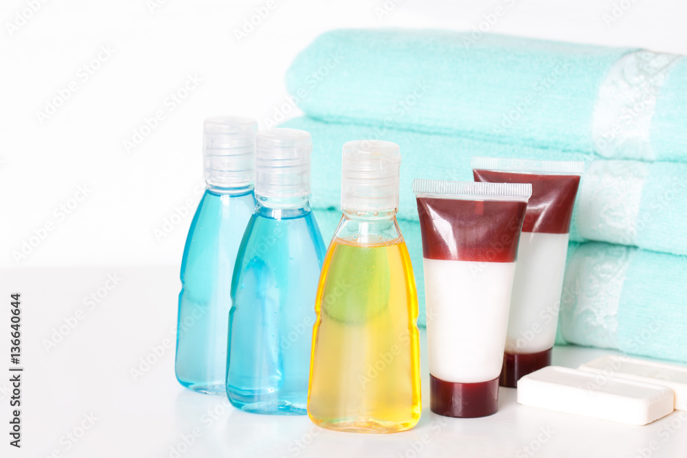 Bathroom accessories. Spa and beauty saloon motif wallpaper. Cosmetics bottles mock ups with shower gel, body lotion or shampoo, tubes with cream, bars of soap and bath towels. Bathroom accessories. Spa and beauty saloon motif wallpaper. Cosmetics bottles mock ups with shower gel, body lotion or shampoo, tubes with cream, bars of soap and bath towels.