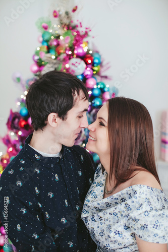 young happy couple near a Christmas tree