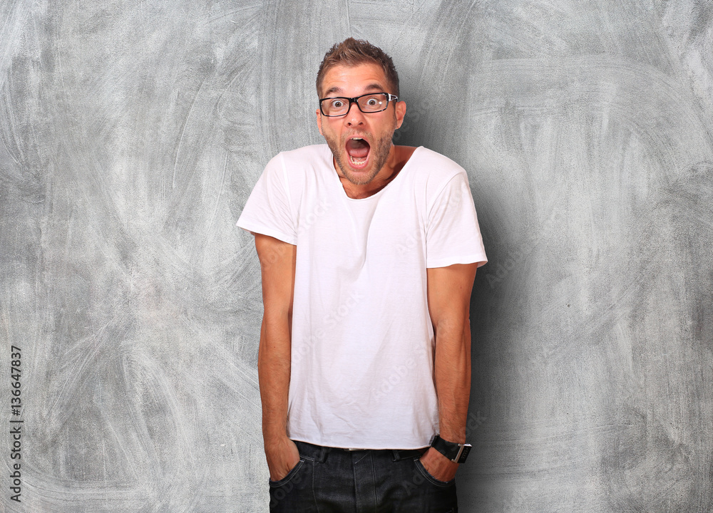 Surprise of the young man in white t-shirt and jeans Surprise of the young man in white t-shirt and jeans