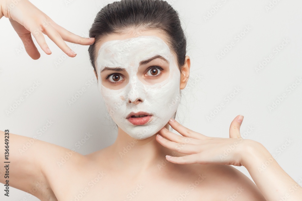 surprised woman with a white mask on her face surprised woman with a white mask on her face