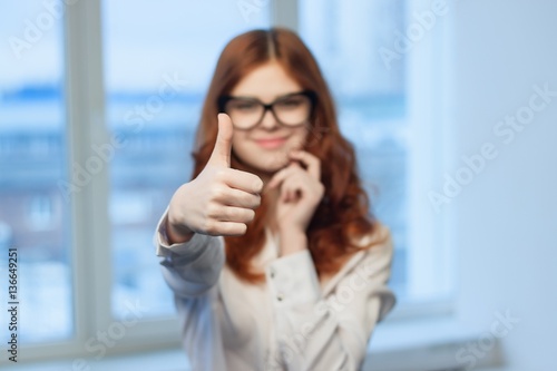happy woman in the office showing thumb