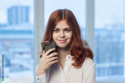 red-haired woman with phone in hand © SHOTPRIME STUDIO