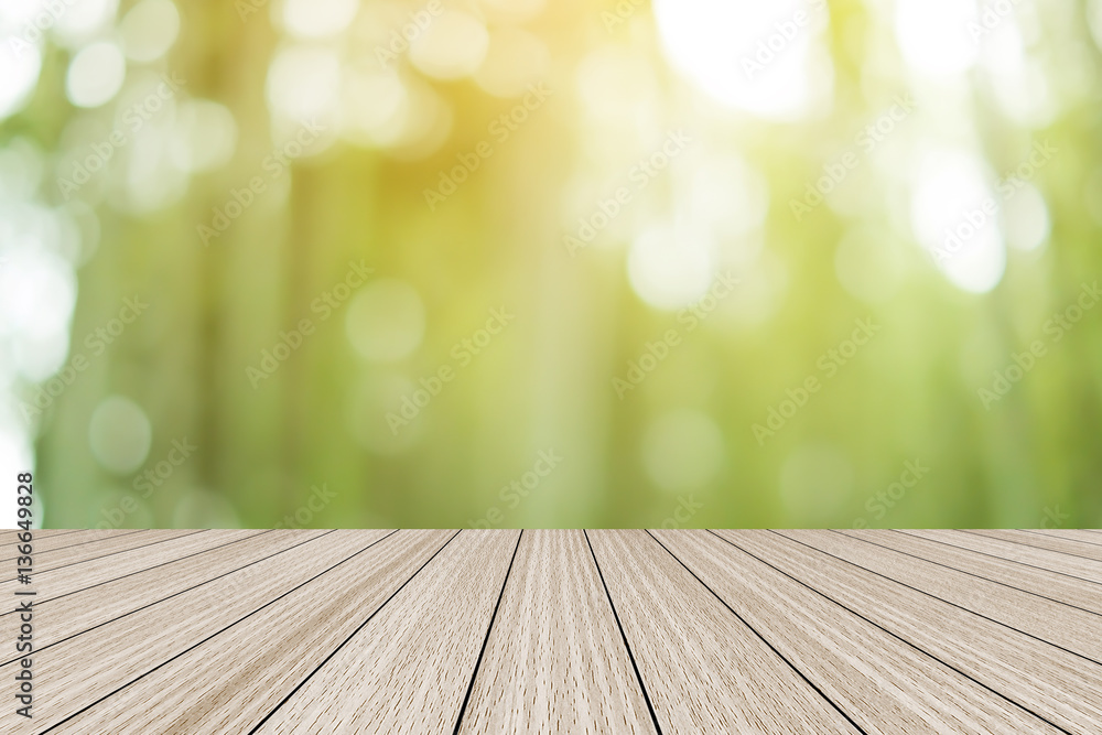 blur nature background with glow sunshine light and modern table top shelf perspective view:blurry green of tree leaves park natural with bokeh motion and tabletop texture wooden for promote montage blur nature background with glow sunshine light and modern table top shelf perspective view:blurry green of tree leaves park natural with bokeh motion and tabletop texture wooden for promote montage