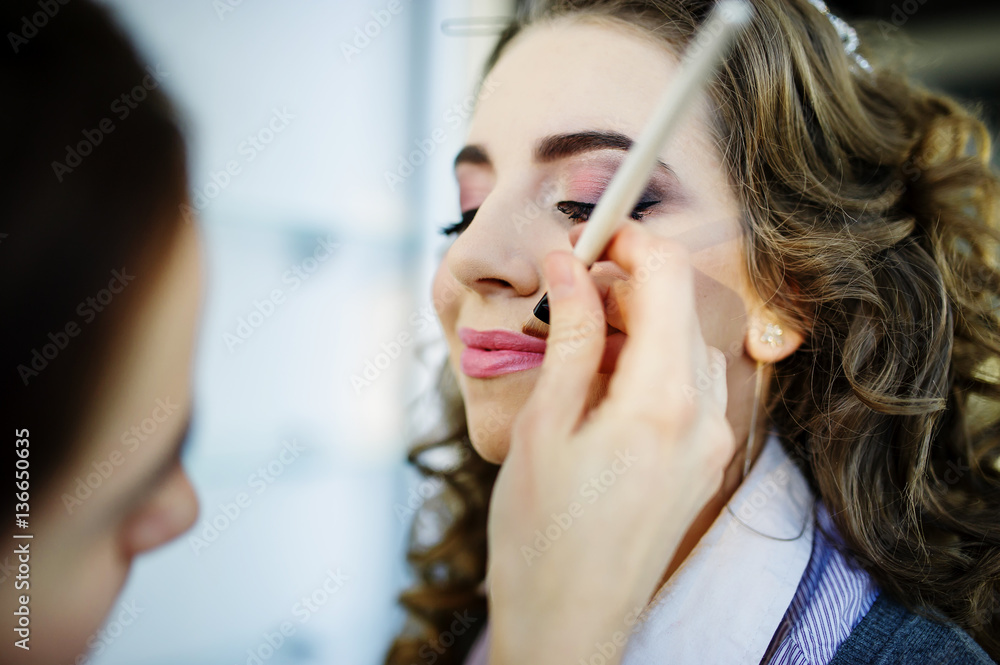 Beautiful young bride with wedding makeup and hairstyle preparat Beautiful young bride with wedding makeup and hairstyle preparat
