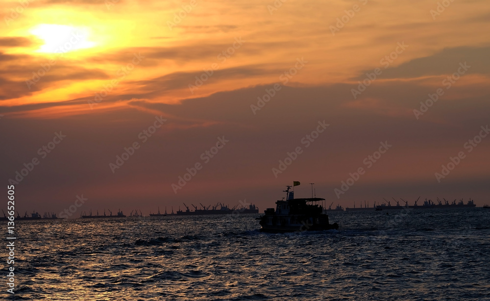 Sunset on the beach with fisherman boat and mountain.