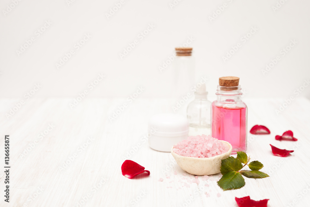 salt, rose water from rose petals with your hands on a white woo salt, rose water from rose petals with your hands on a white woo