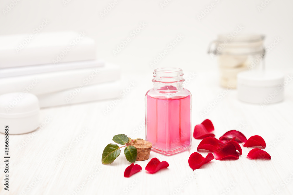salt, rose water from rose petals with your hands on a white woo salt, rose water from rose petals with your hands on a white woo