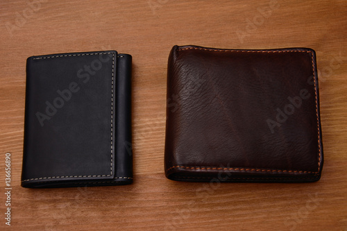 two Leather wallet on wood texture