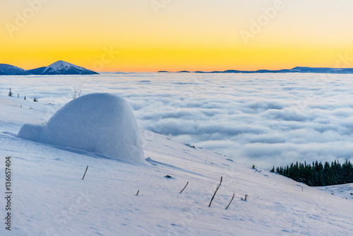 yurt at sunset in winter fog mountains. © standret