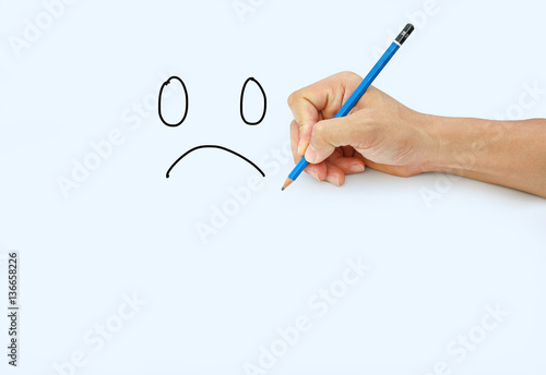 Hand holding a pencil on a white paper background, Drawing with pencil for image of Sad