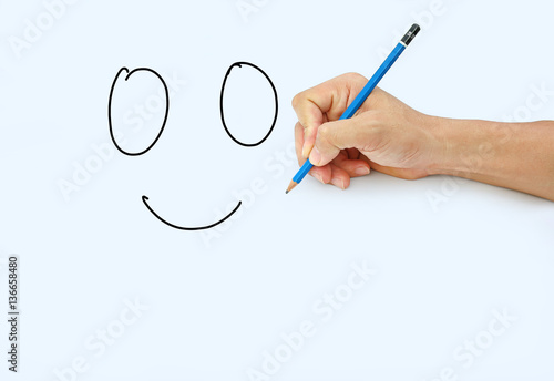 Hand holding a pencil on a white paper background, Drawing with pencil for image of Smile