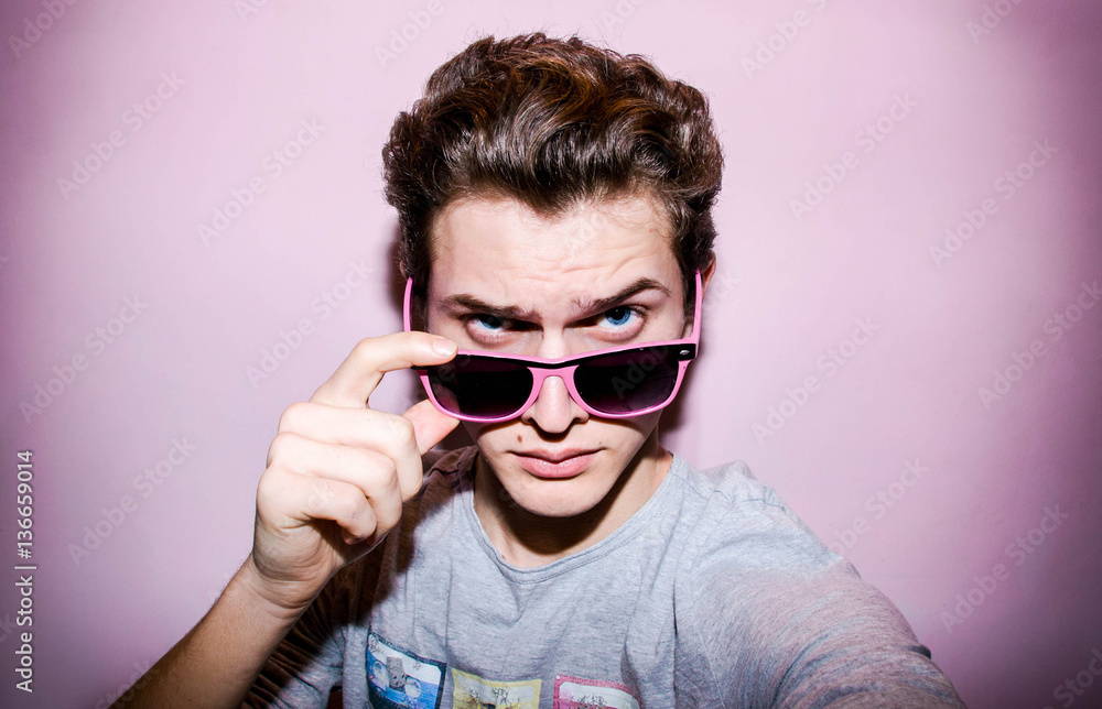 Atrractive young man on the colourful background for shopping Atrractive young man on the colourful background for shopping