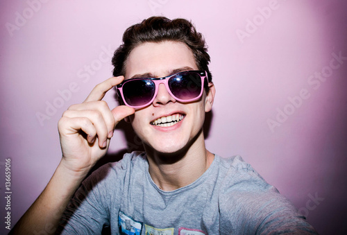 Atrractive young man on the colourful background for shopping