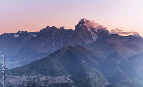 Magic autumn landscape and snow-capped mountain peaks. View of t